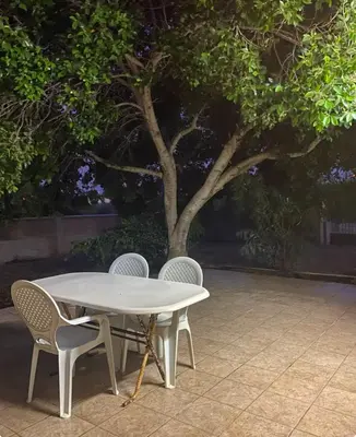 a white table with two chairs and a tree at Comfortable Vacation House in Protaras