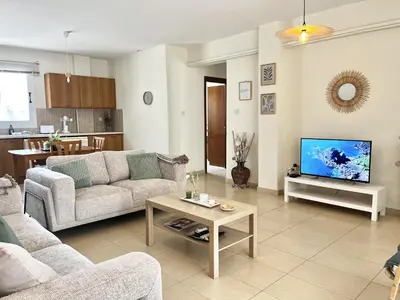 a living room with a couch and a tv at STAY Sunny Palms Penthouse in Voroklini