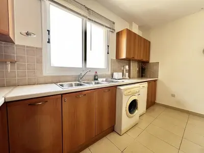 a kitchen with a sink and a washing machine at STAY Sunny Palms Penthouse in Voroklini