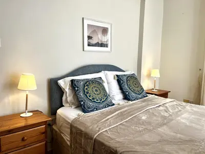 a bedroom with a bed with blue and white pillows at STAY Sunny Palms Penthouse in Voroklini