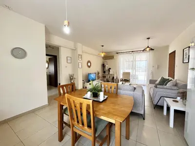 a living room with a table and a couch at STAY Sunny Palms Penthouse in Voroklini