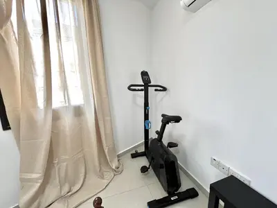 a room with a treadmill next to a window at STAY Sealine Apartment in Larnaka
