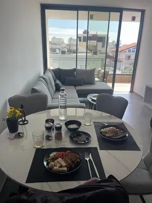a table with plates of food on it in a living room at Modern Designer Home in Larnaka