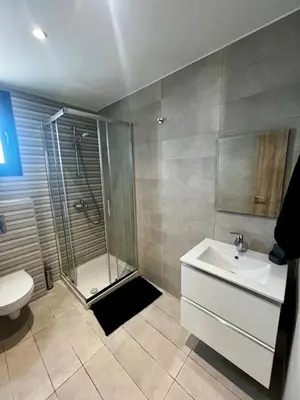 a bathroom with a shower and a sink and a toilet at Modern Designer Home in Larnaka