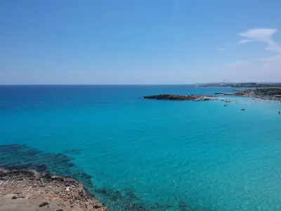 an aerial view of a beach with blue water at Nissi Cove 2 Bedroom Apartment in Ayia Napa