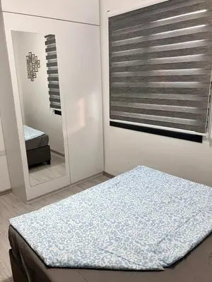 a bedroom with a bed and a mirror at Caesar Socrates Apartment in Larnaka