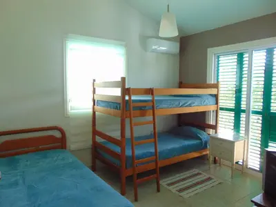 a bedroom with two bunk beds and a window at Konnos Villa in Protaras