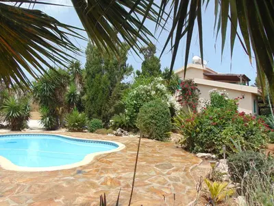a swimming pool in front of a house at Konnos Villa in Protaras