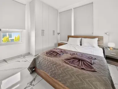 a bedroom with a bed with a blanket on it at Alassia Blue Villa in Protaras