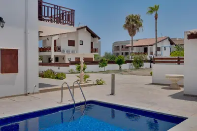 a villa with a swimming pool in front of a house at Amelia Beach Villa wpool -500mfrombeach in Voroklini