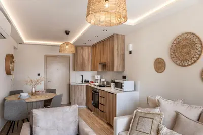 a kitchen and a living room with a table at Pallini 202 in Protaras