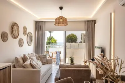 a living room with a couch and a large window at Pallini 202 in Protaras