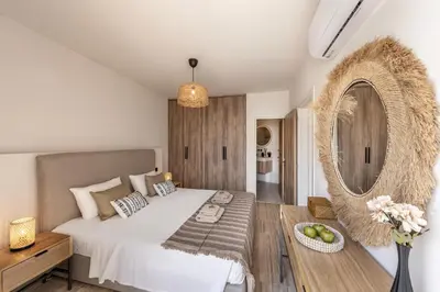 a bedroom with a bed and a mirror and a table at Pallini 202 in Protaras