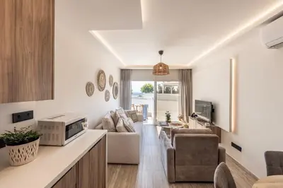 a kitchen and living room with a couch and a tv at Pallini 202 in Protaras