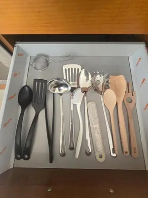 a box full of utensils in a drawer at Lazuli Penthouse City Center Ap 5 in Larnaka