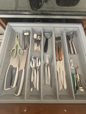 a plastic tray filled with utensils in a drawer at Lazuli Penthouse City Center Ap 5 in Larnaka