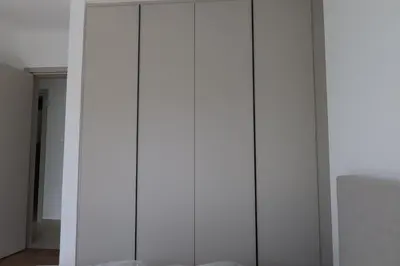 a white wardrobe with glass doors in a room at Alaya Residence in Nicosia