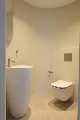 a bathroom with a white toilet and a sink at Alaya Residence in Nicosia