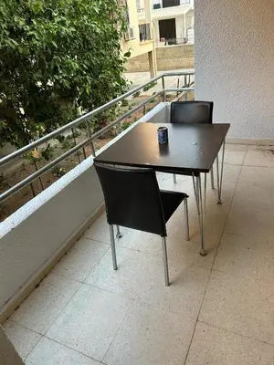 a table and two chairs sitting on a balcony at The relaxing apartment in Paralimni