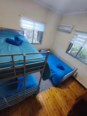 a bedroom with two bunk beds with blue pillows at Casa del Kampos in Kambos