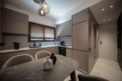 a kitchen with a table with a vase on it at Dest Retreat Beach & City Apt in Limassol