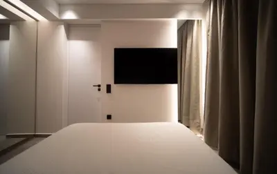a bedroom with a bed and a flat screen tv at Dest Retreat Beach & City Apt in Limassol