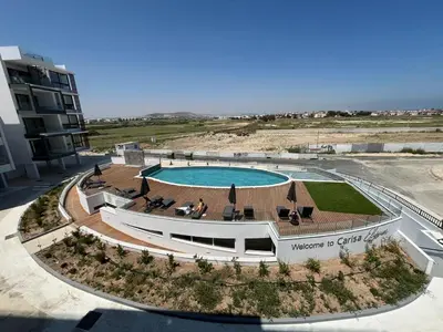 an aerial view of a resort with a swimming pool at Larnaca Elysium Seaside & Pool Retreat in Livadhia