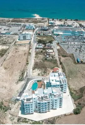 an aerial view of a resort near the ocean at Larnaca Elysium Seaside & Pool Retreat in Livadhia
