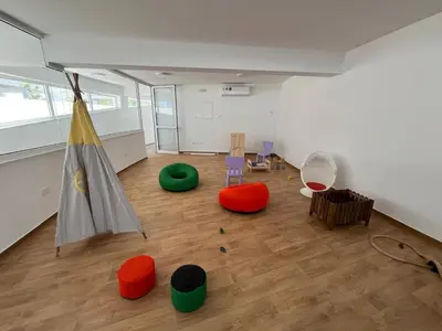 an empty room with a room with colorful furniture at Larnaca Elysium Seaside & Pool Retreat in Livadhia