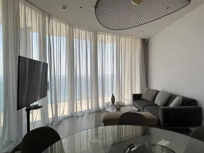 a living room with a couch and a large window at Ayia-Napa Marina Luxury Appartments in Ayia Napa