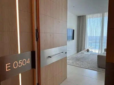 a hotel room with a door with a sign on it at Ayia-Napa Marina Luxury Appartments in Ayia Napa