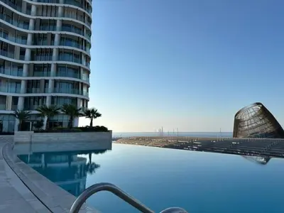 a swimming pool next to a large building and a building at Ayia-Napa Marina Luxury Appartments in Ayia Napa