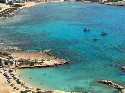 an aerial view of a beach with boats in the water at Ayia-Napa Marina Luxury Appartments in Ayia Napa