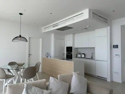 a kitchen and a living room with a couch and a table at Ayia-Napa Marina Luxury Appartments in Ayia Napa