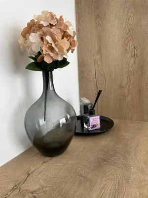 a vase with flowers in it sitting on a table at Four seasons sitesi in Aglantzia