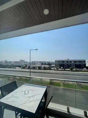 a table on a balcony with a view of a highway at Four seasons sitesi in Aglantzia