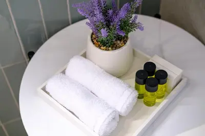 a white table with towels and a plant on it at Artemis 204 - Seaside Stories in Livadhia