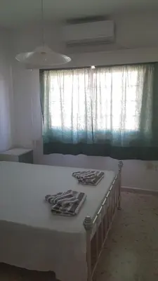 a bed in a room with a window with curtains at Nice Room in Limassol center in Limassol