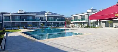 a swimming pool in front of a building at Sunprime Premium Site in Pyla