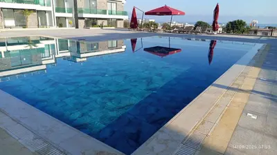 a swimming pool in a building with blue water at Sunprime Premium Site in Pyla