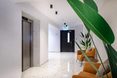 a hallway with a door and a chair and a plant at Artemis 102 - Seaside Stories in Livadhia