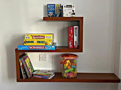 a book shelf with games and books on it at Charm Flat in the heart of the City Center - Balcony & view in Nicosia