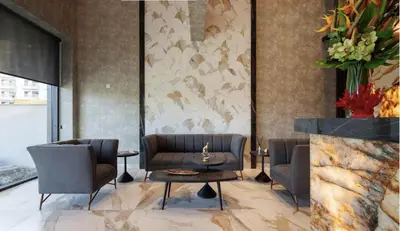 a lobby with chairs and a table and a fireplace at STAY ONLY Tower Suites in Limassol