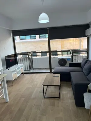 a living room with a couch and a table at El Giorgios City Centre Apartment in Larnaka