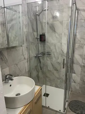a bathroom with a sink and a shower at El Giorgios City Centre Apartment in Larnaka