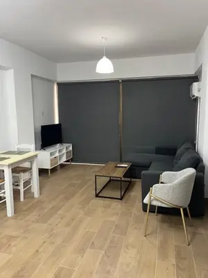 a living room with a couch and a table at El Giorgios City Centre Apartment in Larnaka