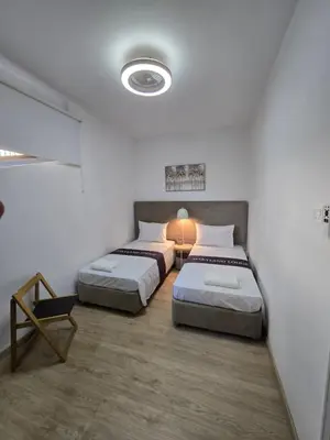 a room with two beds and a table in it at Maryland Lodge hideaway in Kakopetria