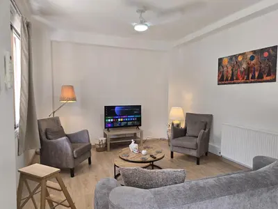 a living room with a couch and chairs and a tv at Maryland Lodge hideaway in Kakopetria