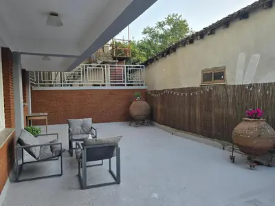 a patio with chairs and vases and a fence at Maryland Lodge hideaway in Kakopetria