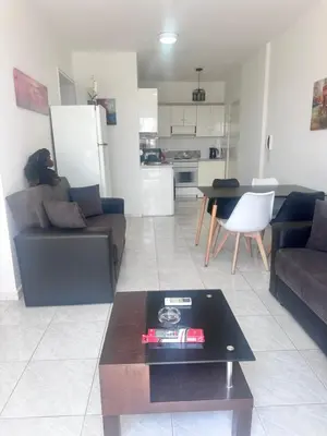 a living room with a couch and a table at Near Makenzie Beach 51 in Larnaka